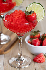 Frozen strawberry daiquiri cocktail with strawberries and lime