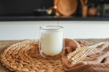 Glass of milk and ears of wheat close up