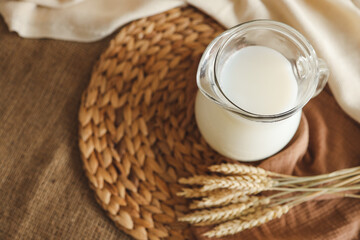 Glass of milk and ears of wheat close up