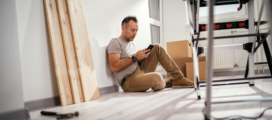 a man planning the interior of the room during the renovation of a new apartment