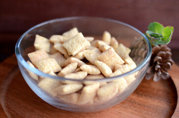 Bowl of Cereal Pillows with wood background, macro view