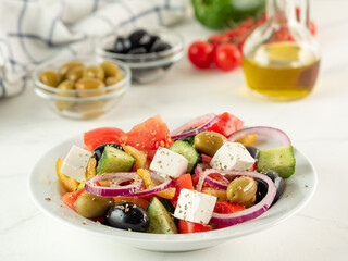 Greek salad on white table