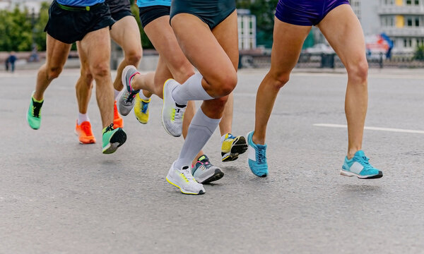 legs group runners, female and male, running marathon. jogger run city race, summer world championships