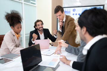 In the meeting room of an international business corporation, a diverse group of young entrepreneurs are enthusiastically taking their ideas and sharing perspectives.