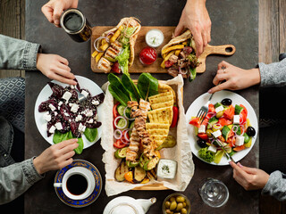 People eating Greek food. Greek cuisine - Powered by Adobe