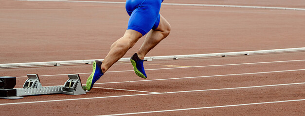legs male sprinter runner start running in starting blocks, athletics competition, summer sports...