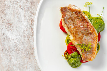 Sea bass fillet with tomatoes and pesto sauce