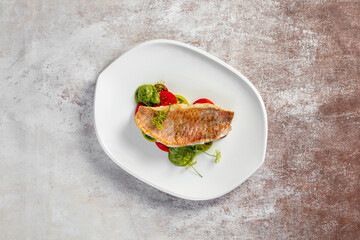 Sea bass fillet with tomatoes and pesto sauce