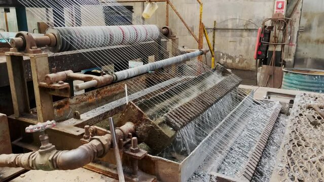 Close up of Machine pulling galvanized wire in production process in industrial factory