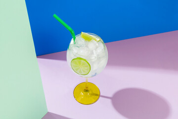 gin cocktail served with iced alcoholic beverage, colored background