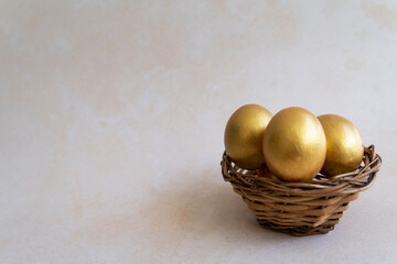 Golden eggs in a basket, Easter related concept Selective focus