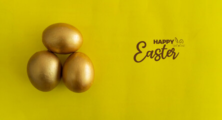  Golden eggs in yellow background, background for Easter Selective focus