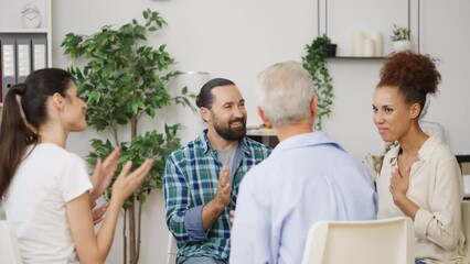 Diverse people congratulating woman on recovery program ending, therapy session