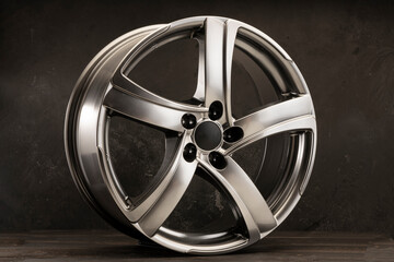 grey shiny alloy wheels for cars, beautiful design in the form of a wave of spokes