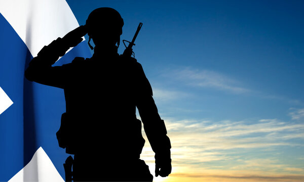Silhouette of a soldier on background of sky and Finland flag. EPS10 vector