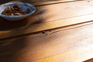 lady bug on the table with bowl of almonds
