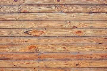 Naklejka premium Texture of wet, brown, narrow, horizontal fence boards