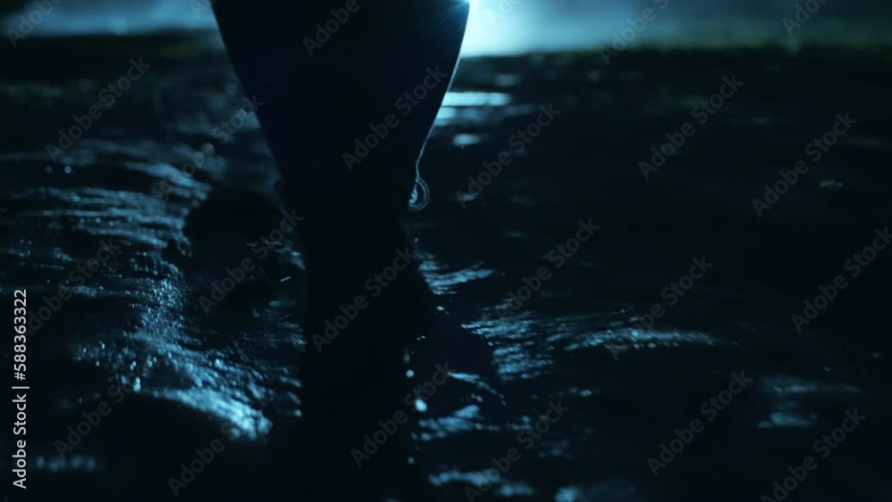 Wall mural a man walking in the dark through the fog and darkness after the rain.