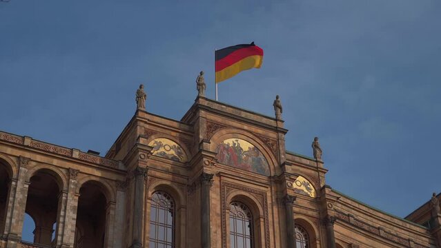 Maximilianeum during renovation and reconstruction. The Bavarian state parliament with flags in Munich, Bavaria, Germany. Bayerischer Landtag Reparatur und Wiederaufbau. Parliament of Bayern. 