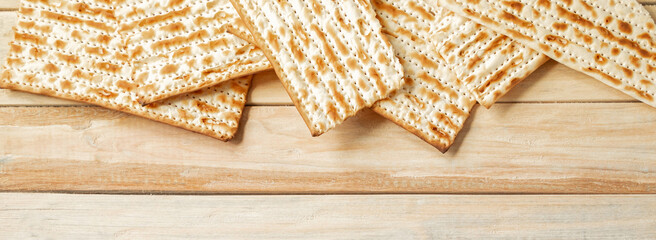 Background for the traditional Jewish holiday Pesach. Passover matzo bread on a wooden table....