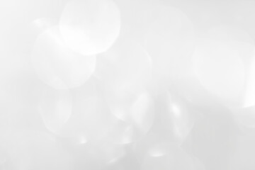 A brilliant white background with circles and ovals. Template for a holiday card with bright and sparkling lights.