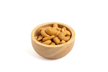 Salted cashews in a small wooden bowl on a white background. Cashew nuts are nutritious foods rich...