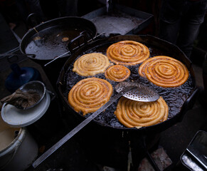 Delicious Testy sweet  jalebi fried in the cooking pan on a street food market in Chakbazar, Dhaka-Bangladesh