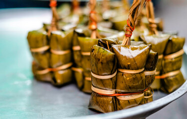 Glutinous rice seasoned with sugar and coconut milk, topped with banana leaves, made into porridge...