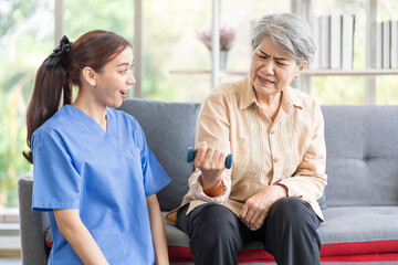 Fototapeta premium Asian women are being cared for by nurses who monitor health and physical therapy for elderly women living alone at home. by walking on a cane or using muscles