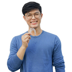 close up young asian man smiling with hand holding dental aligner retainer (invisible) at dental clinic for beautiful teeth treatment course and png design concept