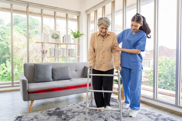 Asian women are being cared for by nurses who monitor health and physical therapy for elderly women living alone at home. by walking on a cane or using muscles