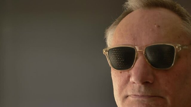 Senior man with Pinhole glasses at home