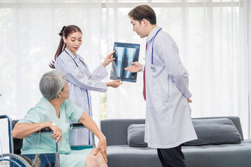 Fototapeta na wymiar Asian doctor professionally examining a patient's x-ray to analyze the disease for the patient