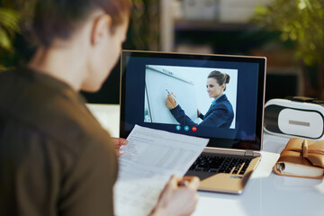 Seen from behind modern business woman using video chat