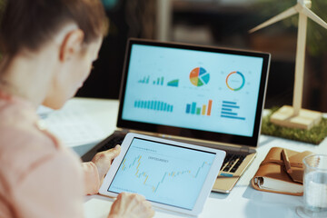 female using tablet PC and analysing business investment market