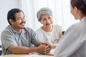 Asian seniors who are healthy, in a good mood, smiling, talking with financial or life insurance...