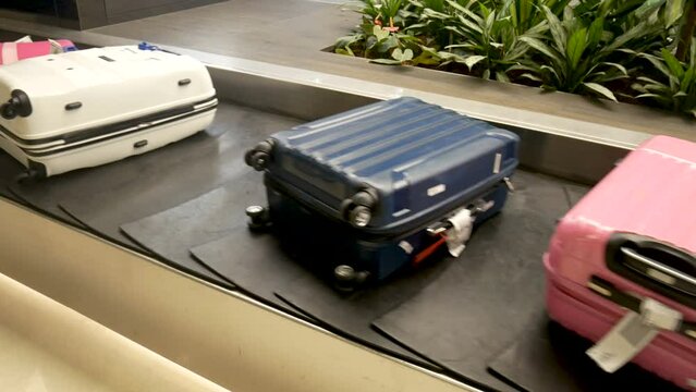 process of baggage claim for arrival passenger at international airport. various suitcases on conveyor belt at the airport. luggage travels on a conveyor belt