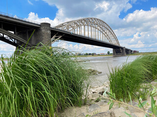 Steel arch bridge Waalbrug in Nijmegen, Netherlands over the river Waal - 588378584