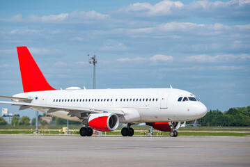 Fototapeta na wymiar Passenger airplane on runway at sunny day