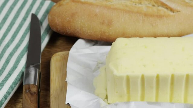 plaquette de beurre au sel de mer et baguette de pain, en gros plan