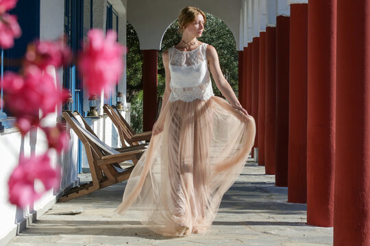 Fashion portrait of woman in white lace top and chiffon long maxi beige skirt, boho wedding outfit, summer vacation fashion