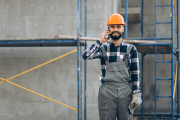 Foreman talking on the phone at the building object