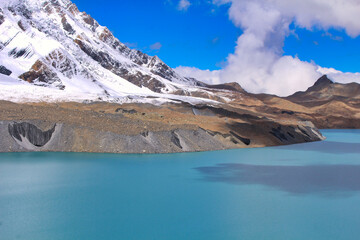 Fototapeta na wymiar The deep luminescent blue of one of the highest lakes in the world - Tilicho Lake at 4910 meters above sea level, just below Tilicho peak, on the Annapurna circuit trek