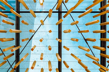 Abstract background look up at hanging wooden blocks on glass ceiling