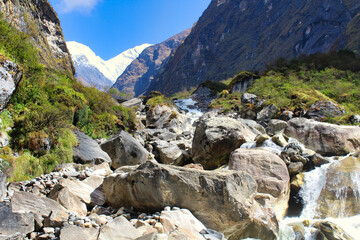 Mount Hiunchuli and Annapurna South loom over the narrow valley of the Modi khola on the way towards Deurali along the Annapurna base camp trek