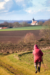 Woman walking on a path outdoors, hiking pratice for relaxing and staying healthy