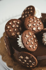 Delicious homemade dark chocolate cake with chocolate cookies and cream on top