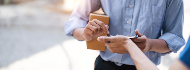 customer signature in mobile phone, man receiving parcel box from courier with delivery service man, express delivery, online shopping concept - obrazy, fototapety, plakaty