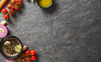 Ingredients for cooking. Food background with spices, olive oil and vegetables on dark background...