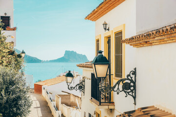 Altea old town with narrow streets and whitewashed houses in Alicante province, Valencian Community, Spain. Small picturesque village of Altea with Mediterranean sea and Ifach rock in background